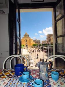 a table with a view of a city from a window at Esclusiva in Favignana