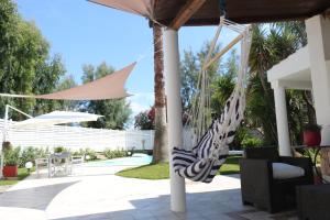 a hammock on the porch of a house at Edri beach house in Pontecagnano