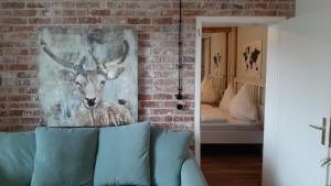 a painting of a deer on a brick wall at 4 Sterne Wohnen "Zum alten Forsthof" am Schlosspark, App 3 "wunnerbor" in Eutin