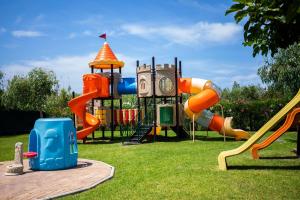 a playground with a slide and a clock at Valtur Il Cormorano Resort & Spa in Grisolia