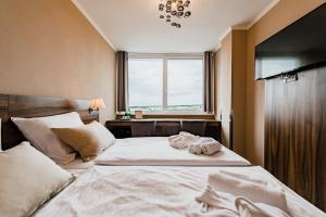 Łóżko lub łóżka w pokoju w obiekcie Hotel Palcát