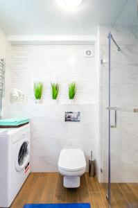 a bathroom with a toilet and a washing machine at ARTAL Apartment on Obolonskyi Avenue 31 in Kyiv