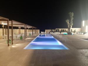 
a swimming pool with a pool table in it at Tenuta Danesi in Matera
