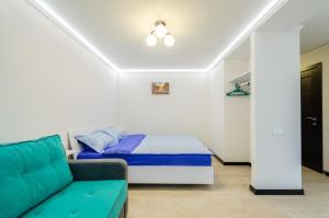 a small bedroom with a bed and a couch at ARTAL Apartment on Obolonskyi Avenue 31 in Kyiv