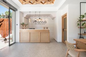 a kitchen with a wooden counter and a table at Mossa Well Being Hotel - Heated pool and Wellness Spa in Kato Daratso