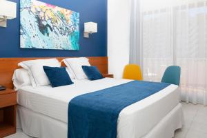 Postel nebo postele na pokoji v ubytování Hotel Jaime I
