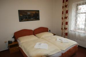 Posteľ alebo postele v izbe v ubytovaní Hotel Maria