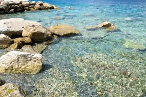 a group of rocks and the crystal clear water at Il corallo azzurro in Reggio di Calabria