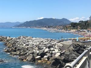 a large group of rocks in the water near a beach at Villa Fieschi in Lavagna