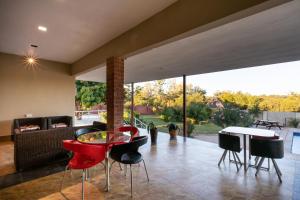 a living room with a red table and chairs at Nzubo Experience in Livingstone