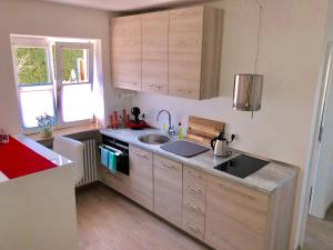 a kitchen with a sink and a stove top oven at Wolfˋs Apartment in Neubeuern