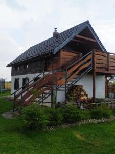 a log home with a gambrel roof at Koniczynka Jarosławiec in Jezierzany