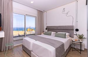 a bedroom with a large bed and a large window at Constantinos Villa, Sublime Island Εscape, By ThinkVilla in Panormos Rethymno +39 photos