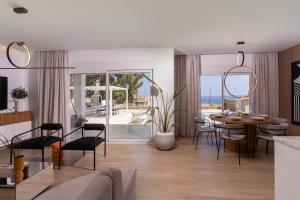 a living room with a table and a dining room at Constantinos Villa, Sublime Island Εscape, By ThinkVilla in Panormos Rethymno