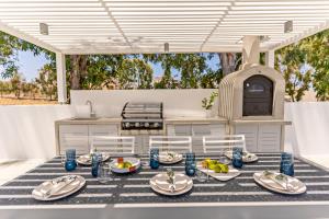 a table with plates of food on it in a kitchen at Constantinos Villa, Sublime Island Εscape, By ThinkVilla in Panormos Rethymno