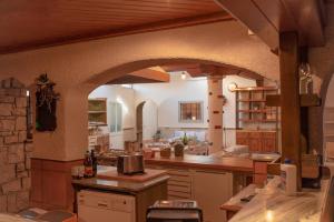 a large kitchen with an archway in a building at Apartment Ana - Karst Cycling Paradise in Dutovlje