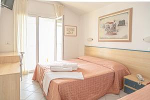 Postel nebo postele na pokoji v ubytování Hotel Royal Inn