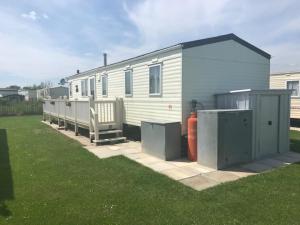 a small white house with a fire hydrant in a yard at G17 The Chase , Ingoldmells, Skegness in Ingoldmells