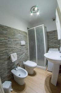 a bathroom with a sink and a toilet and a shower at Villa Giambona in Isola delle Femmine