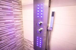 a shower with purple lights in a bathroom at Green house in Orvieto +16 photos