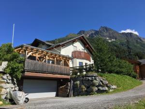 a house with a balcony on the side of it at ARLALPIN in Pettneu am Arlberg