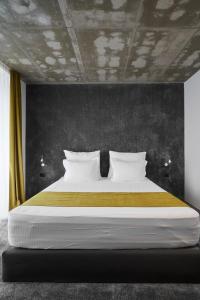 
a bed in a room with a white bedspread at Adella Boutique Hotel in Sofia
