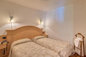 Ένα ή περισσότερα κρεβάτια σε δωμάτιο στο Albergo Moleta