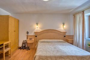 Ένα ή περισσότερα κρεβάτια σε δωμάτιο στο Albergo Moleta