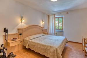 Ένα ή περισσότερα κρεβάτια σε δωμάτιο στο Albergo Moleta