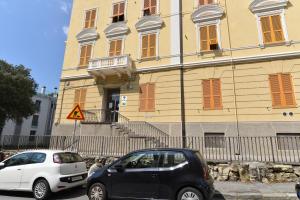 two cars parked in front of a building at A&B Affittacamere a Boccadasse in Genoa