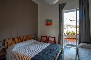 Schlafzimmer mit einem Bett und einer Glasschiebetür in der Unterkunft Tui Beds in Arenzano