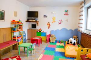 a childs room with colorful furniture and toys at Alphotel Milano in Andalo