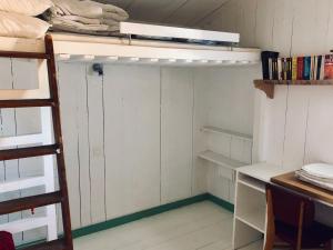 a room with a bunk bed and a desk at Logement Design à Loix-en-Ré - 2 étoiles - Centre Village in Loix