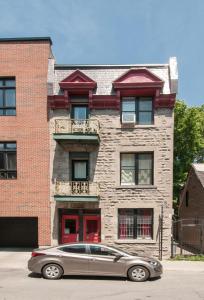 a car parked in front of a brick building at 100 METERS to SUBWAY - Montcalm condos in Montréal
