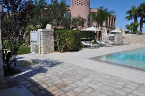 a villa with a swimming pool and a fence at Villa Rosa Antico Dimora Storica in Otranto