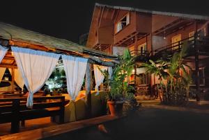 a restaurant with curtains in front of a building at Guesthouse Vila Druri Dhermi in Dhërmi