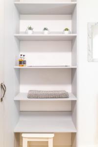 a shelf in a bathroom with white shelves at 39 Hamilton Street in Cardiff