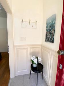 a room with a table with flowers on it at Basic Little House Scheveningen in Scheveningen