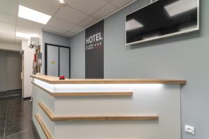 an office lobby with a hotel sign on the wall at Hotel des Congrès et Festivals in Cannes