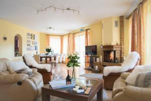 a living room with couches and a table at Charming Villa in a Private Mountain Resort in Braşov