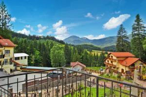 a view from the balcony of a resort with mountains at Charming Villa in a Private Mountain Resort in Braşov