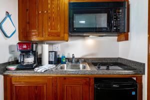 a kitchen with a sink and a microwave at Hotel de la Monnaie in New Orleans