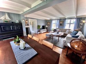 a living room with a couch and a fireplace at Villa Edvin - Slow living in Eide
