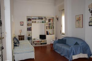 a living room with a couch and a chair at Terrazza in borgo San Jacopo in Florence