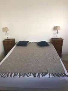 a bedroom with a bed with two night stands at L îlot Grec in Saint-Palais-sur-Mer