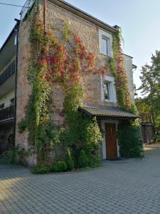 a building with flowers on the side of it at Leśna Villa in Wiśniówka Mała