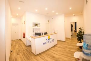 a salon with a counter with a sign on it at Hostal Boutique Luz del Sol Barbate in Barbate