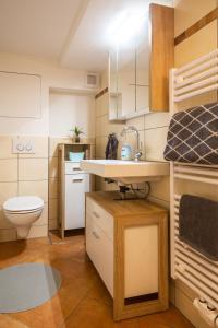 a small bathroom with a sink and a toilet at Ferienwohnung Casa Sophia in Seeheim-Jugenheim