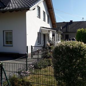 a white house with a fence in front of it at Wershofen/Eifel in Wershofen