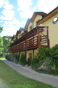 a large building with wooden panels on it at Hotel Tenis in Chrząstowice